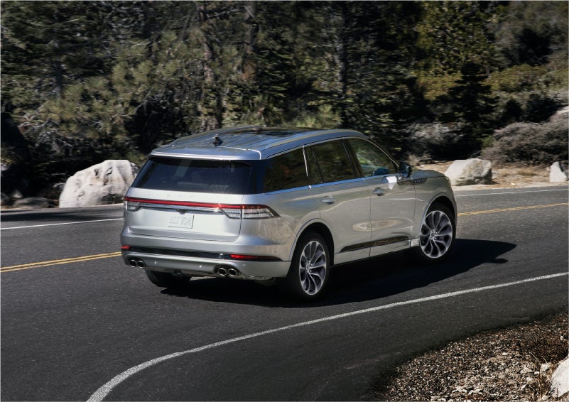 A 2023 Lincoln Aviator® Grand Touring model is shown being driven on a tight turn of a mountain road | Randy Marion Lincoln in Statesville NC
