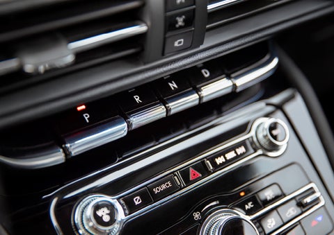 The Park button on the elegant Piano Key Shifter is lit up and engaged as light dances off the chrome accents and horizontal design lines | Randy Marion Lincoln in Statesville NC