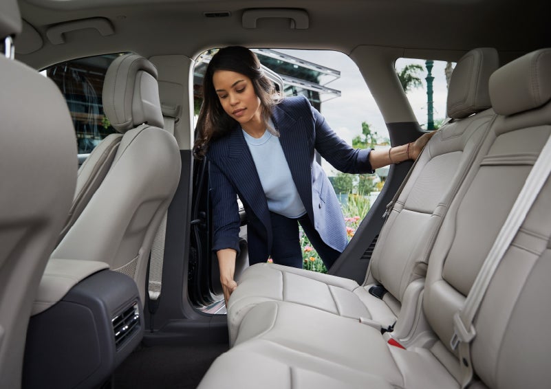 A woman slides the second-row seat forward to create more cargo space | Randy Marion Lincoln in Statesville NC