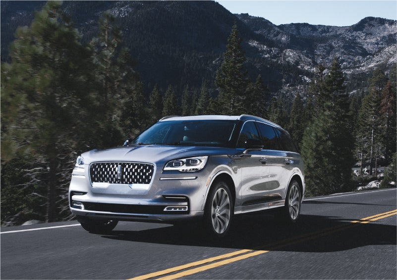 A 2023 Lincoln Aviator® Grand Touring SUV being driven on a winding road to demonstrate the capabilities of all-wheel drive | Randy Marion Lincoln in Statesville NC