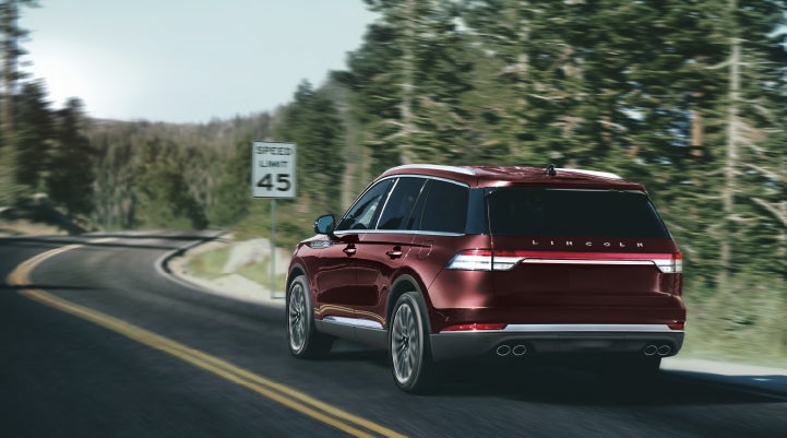 A 2024 Lincoln Aviator® SUV is being driven on a winding mountain road | Randy Marion Lincoln in Statesville NC