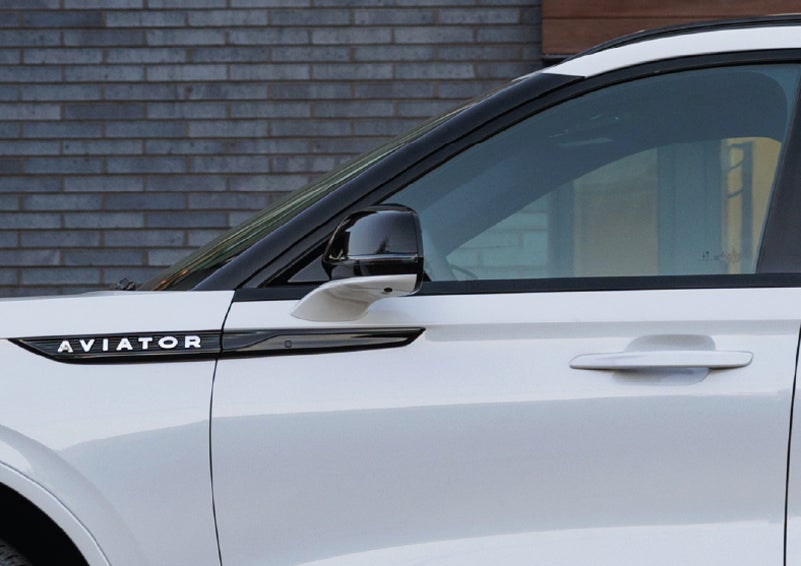 The driver’s side door and fender badging of a white 2026 Lincoln Aviator® SUV are showcased. | Randy Marion Lincoln in Statesville NC