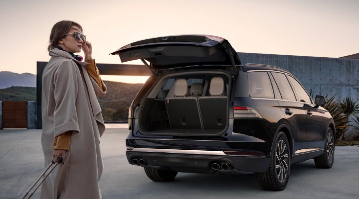 A woman approaches a 2026 Lincoln Aviator® SUV with its rear liftgate open. | Randy Marion Lincoln in Statesville NC