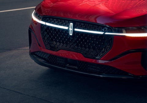 The available front LED light bar and center Lincoln Star logo glow at dusk. | Randy Marion Lincoln in Statesville NC