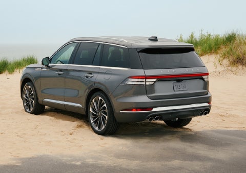 A 2027 Lincoln Aviator® SUV is parked next to sand dunes. | Randy Marion Lincoln in Statesville NC