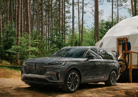 A 2027 Lincoln Aviator® is parked next to a high end glamping site. | Randy Marion Lincoln in Statesville NC
