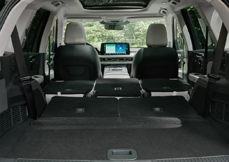 A rear to front view of the interior of a 2027 Lincoln Aviator® Black Label™ SUV shows the third and second rows folded flat | Randy Marion Lincoln in Statesville NC