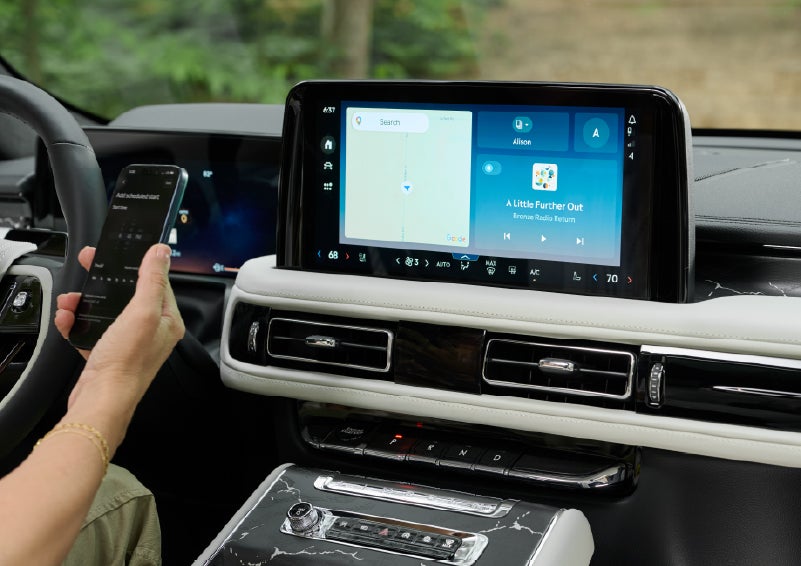 A person pairs thier phone with the center touchscreen of a 2027 Lincoln Aviator® Black Label™ SUV | Randy Marion Lincoln in Statesville NC
